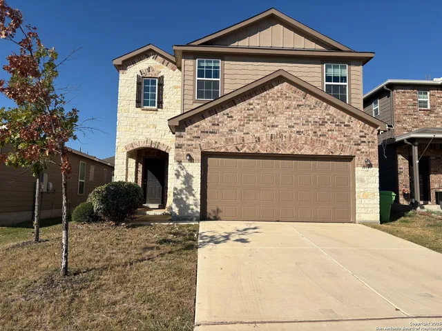 a front view of a house with a yard and garage