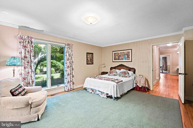 a spacious bedroom with a large bed and a large window