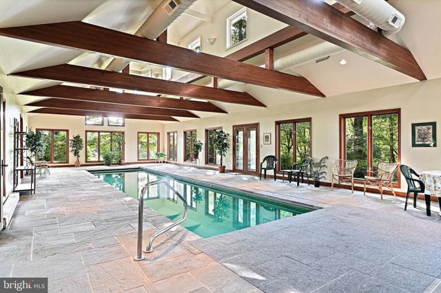 a view of an empty room with a window and hardwood floor