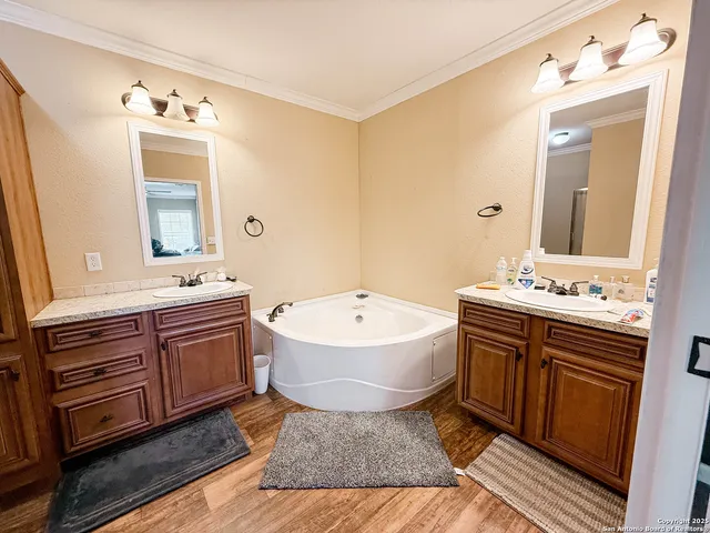 a bathroom with a granite countertop sink mirror and bathtub