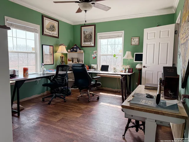 a view of a workspace with furniture and a window