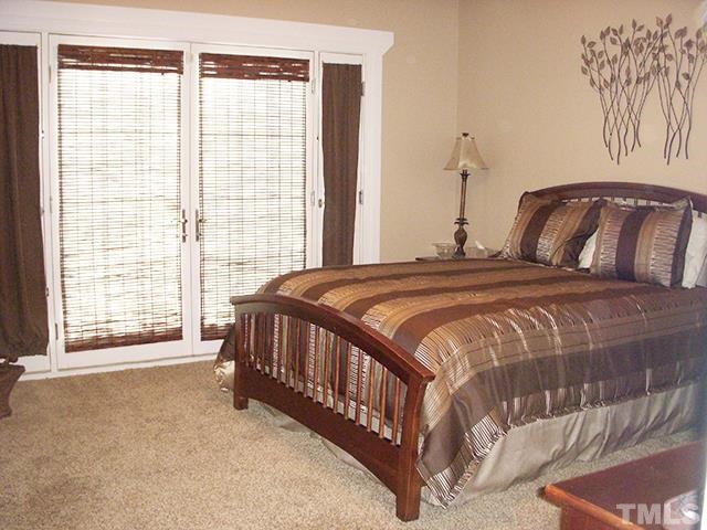 3809 Cathedral Bell Road Raleigh, NC 27614 - Photo 11 of 25 a bedroom with a bed and a large window