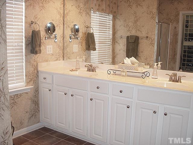 3809 Cathedral Bell Road Raleigh, NC 27614 - Photo 12 of 25 a bathroom with double vanity and a mirror