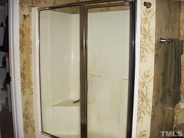 3809 Cathedral Bell Road Raleigh, NC 27614 - Photo 13 of 25 a bathroom with a glass shower door and a shower