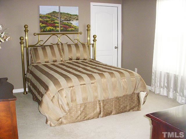 3809 Cathedral Bell Road Raleigh, NC 27614 - Photo 17 of 25 a bedroom with a bed and a chandelier