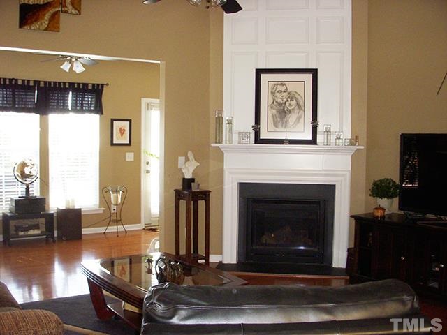 3809 Cathedral Bell Road Raleigh, NC 27614 - Photo 4 of 25 a living room with furniture and a fireplace