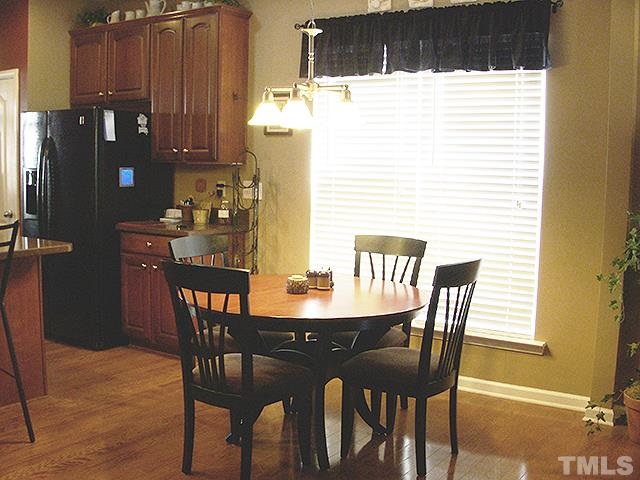 3809 Cathedral Bell Road Raleigh, NC 27614 - Photo 7 of 25 a dining room with furniture and wooden floor
