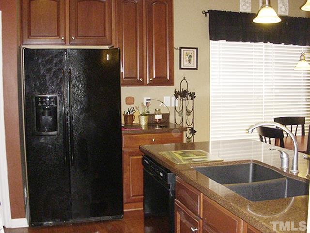 3809 Cathedral Bell Road Raleigh, NC 27614 - Photo 9 of 25 a kitchen with a sink and cabinets