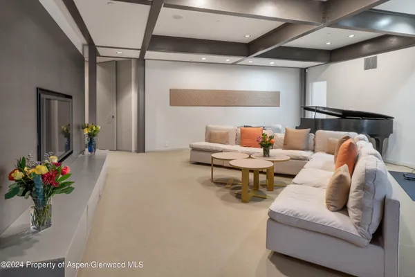 a living room with furniture and flowers