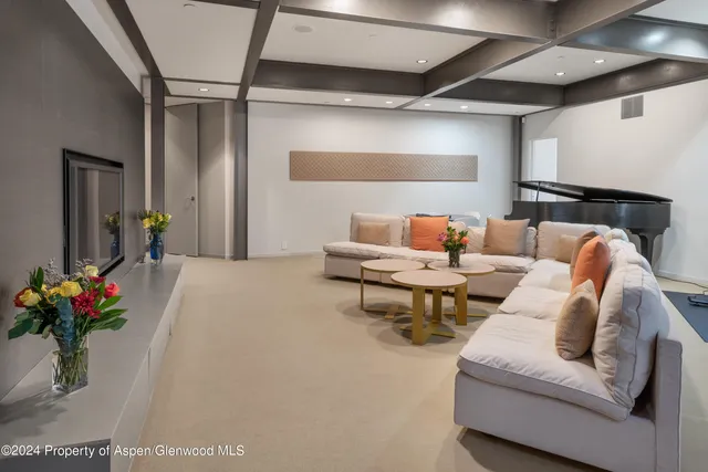 a living room with furniture and flowers