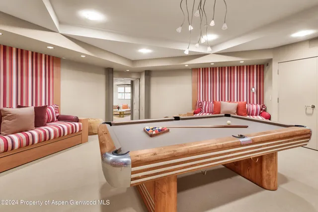 a room with furniture pool table and windows