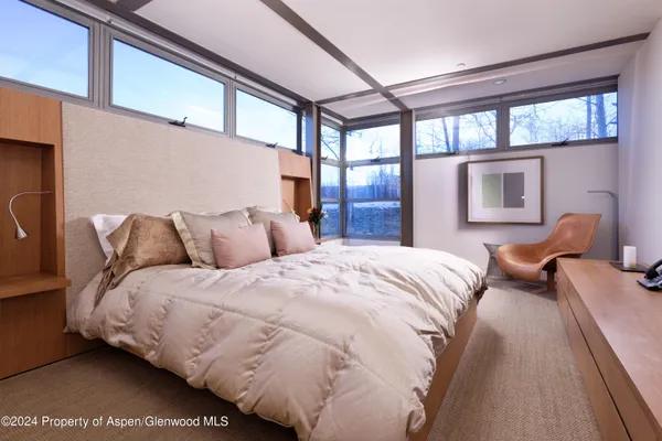 a bed sitting in a bedroom next to a window