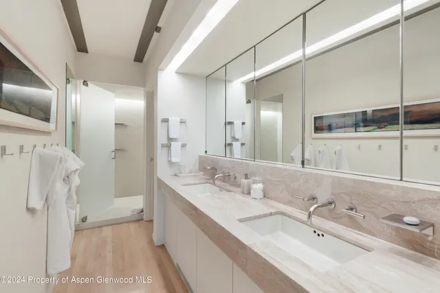 a bathroom with a tub sink and mirror