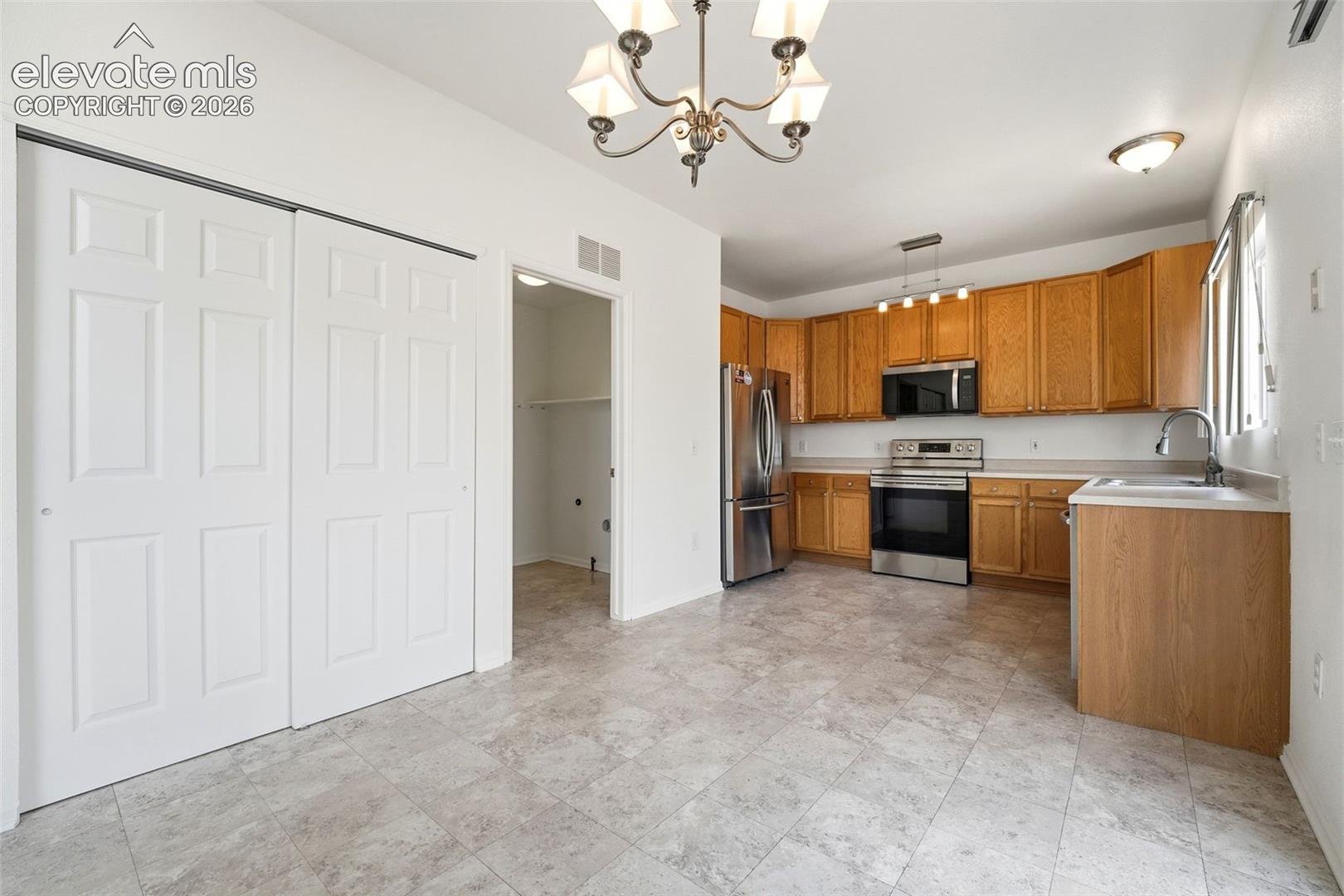 7904 Coffee Road Peyton, CO 80831 - Photo 15 of 48 Kitchen area featuring wood-finish cabinetry and stainless steel appliances