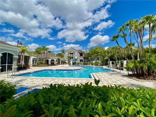 a view of yard with swimming pool and green space