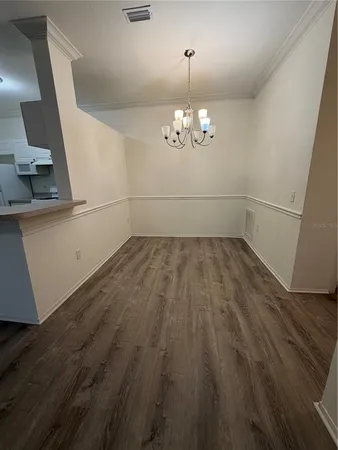 a view of a room with wooden floor and stove