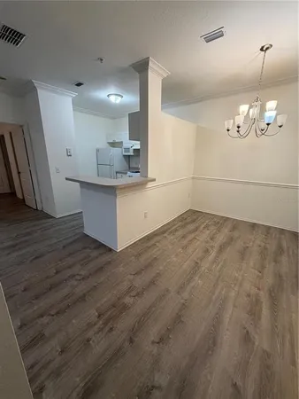 a view of a kitchen with wooden floor and a sink