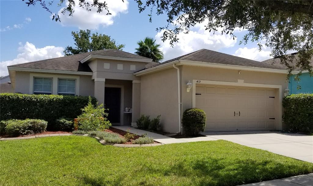 419 Kings Path Drive Seffner, FL 33584 - Photo 1 of 1 a front view of a house with a yard and garage