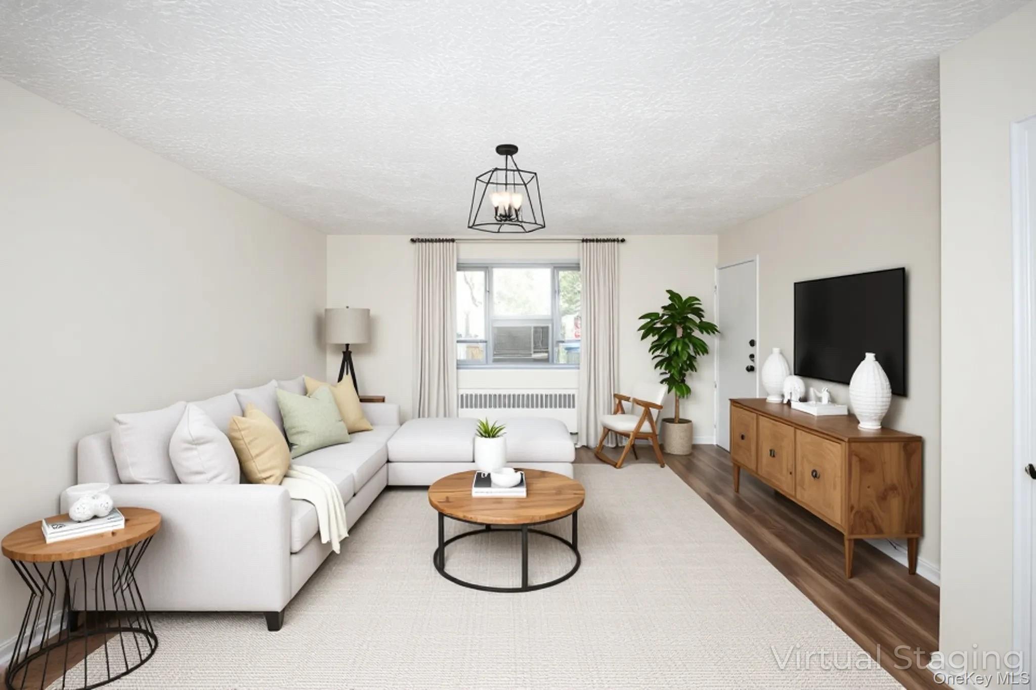 220-04 Stronghurst Avenue, Unit 185 Queens, NY 11427 - Photo 11 of 33 a living room with furniture and a flat screen tv