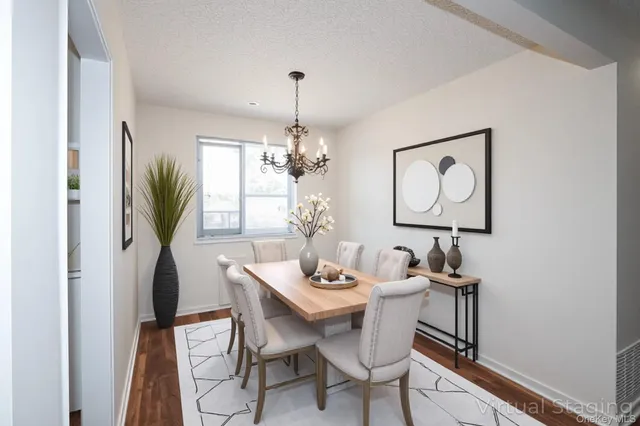 a view of a dining room with furniture and a chandelier