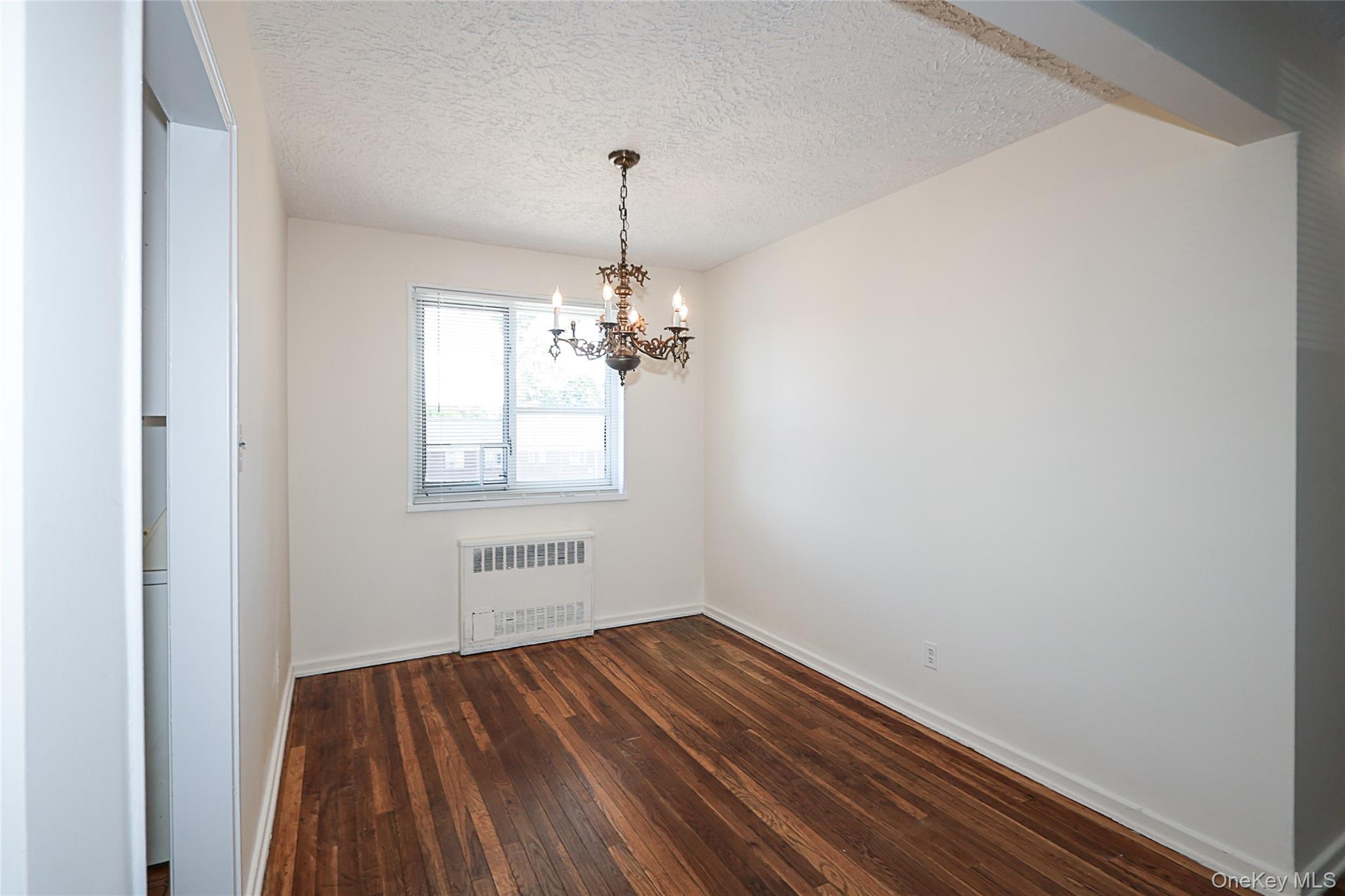 220-04 Stronghurst Avenue, Unit 185 Queens, NY 11427 - Photo 15 of 33 a view of a room with wooden floor and windows