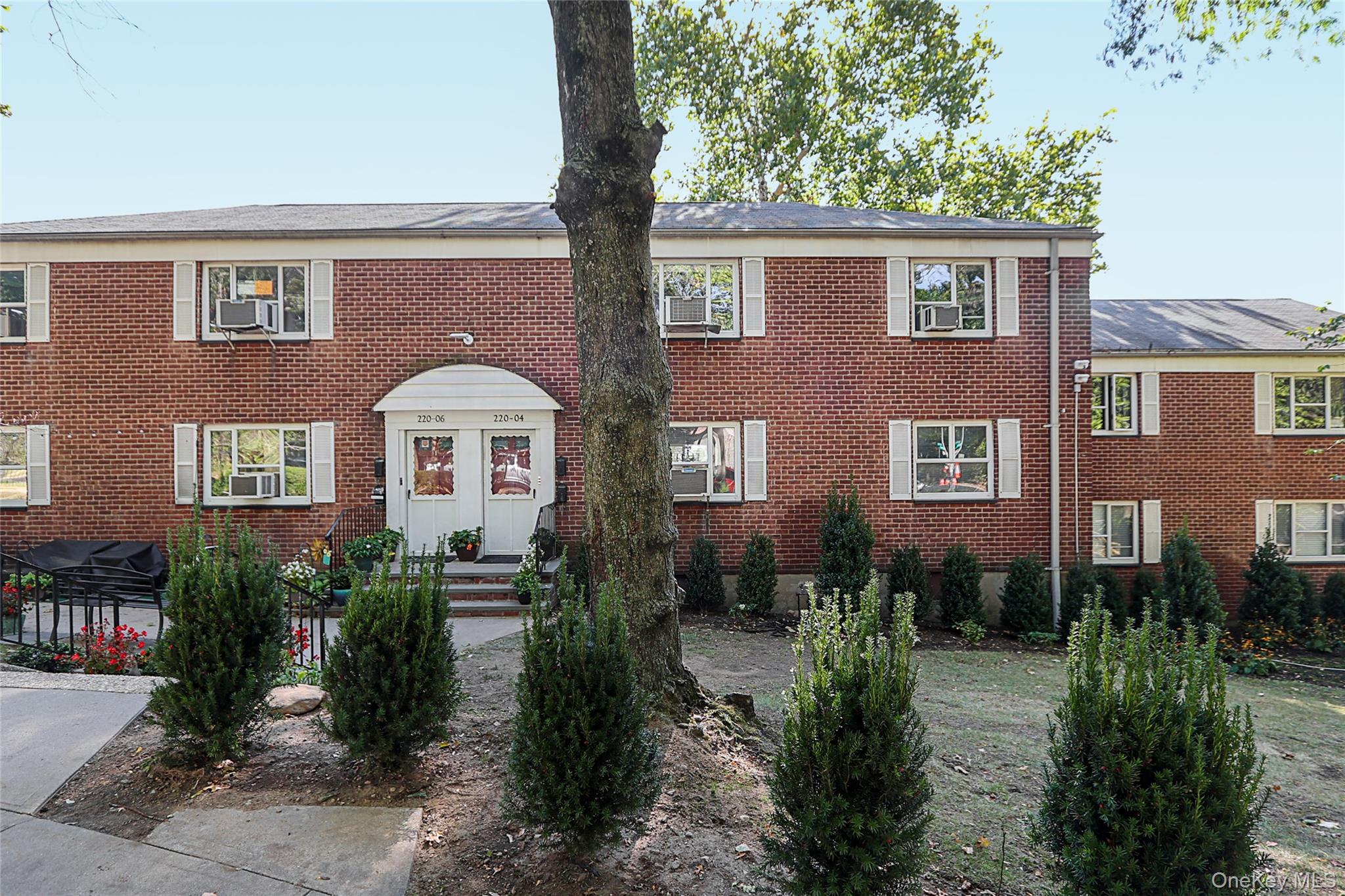 220-04 Stronghurst Avenue, Unit 185 Queens, NY 11427 - Photo 2 of 33 a front view of a house with a yard