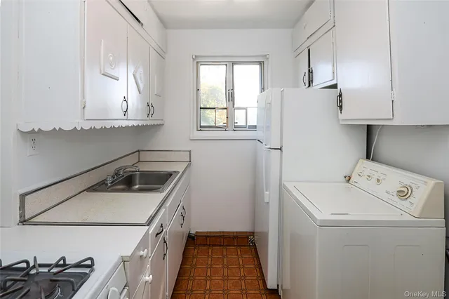 a kitchen with a sink a stove and refrigerator