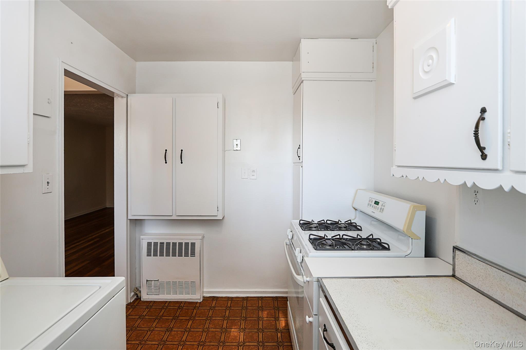 220-04 Stronghurst Avenue, Unit 185 Queens, NY 11427 - Photo 24 of 33 a kitchen with cabinets and stove top oven