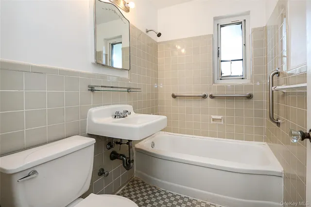 a bathroom with a sink a toilet and bathtub