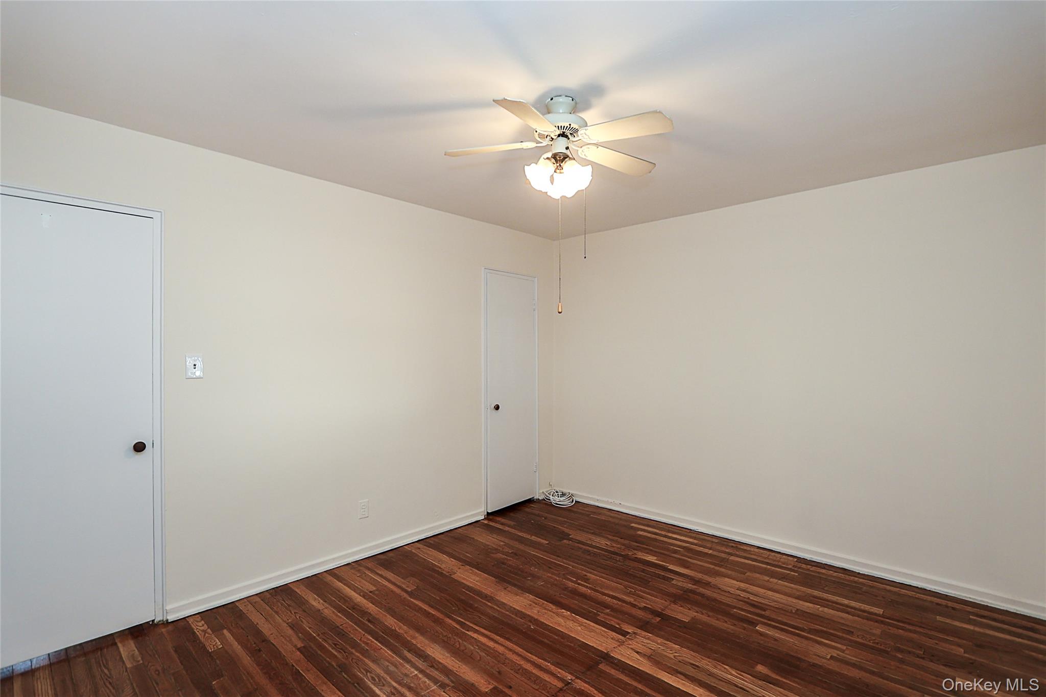 220-04 Stronghurst Avenue, Unit 185 Queens, NY 11427 - Photo 30 of 33 a view of an empty room with wooden floor