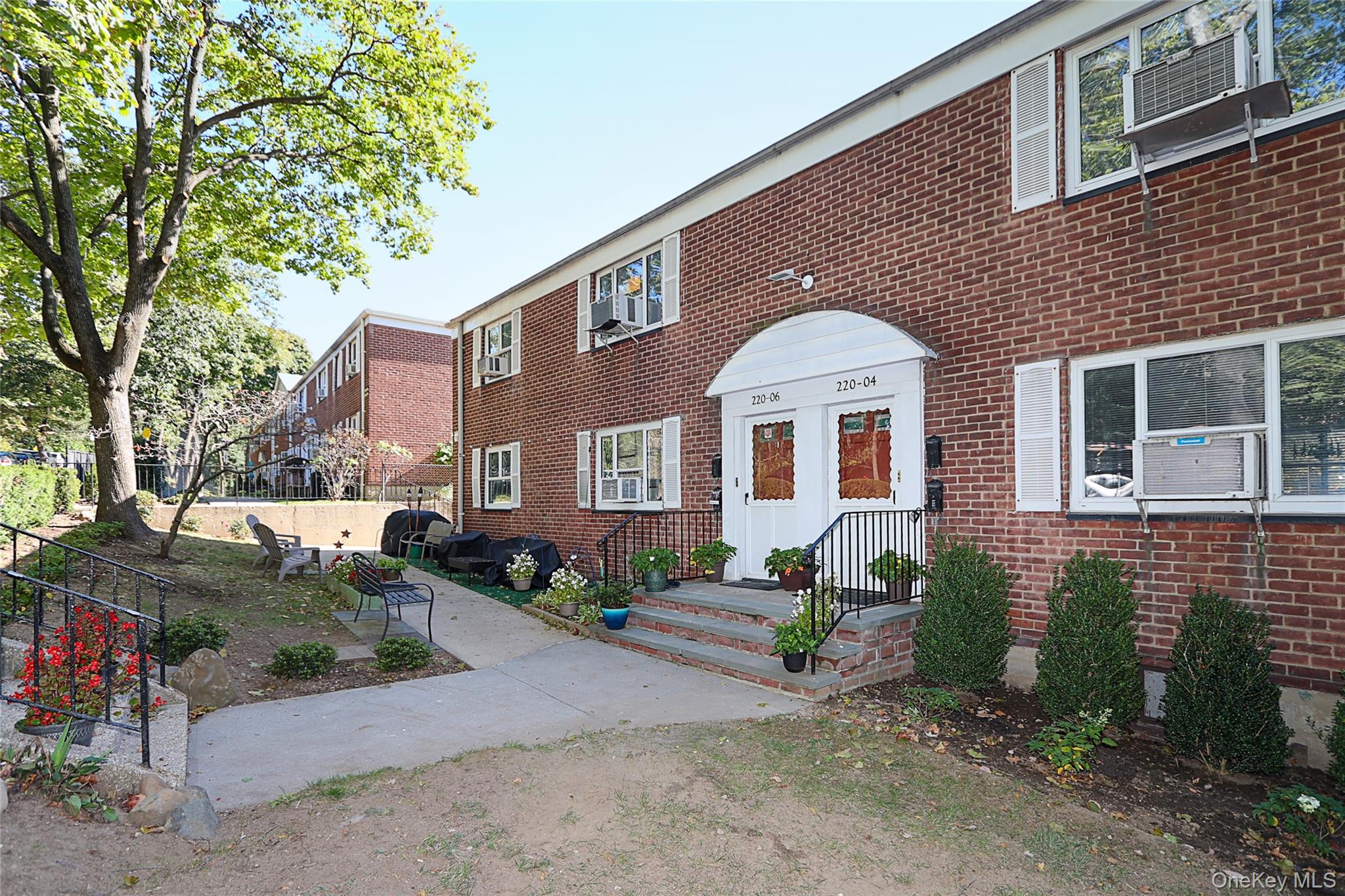 220-04 Stronghurst Avenue, Unit 185 Queens, NY 11427 - Photo 33 of 33 a front view of a house with garden