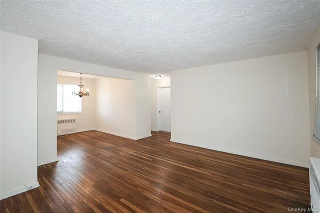 a view of an empty room and wooden floor