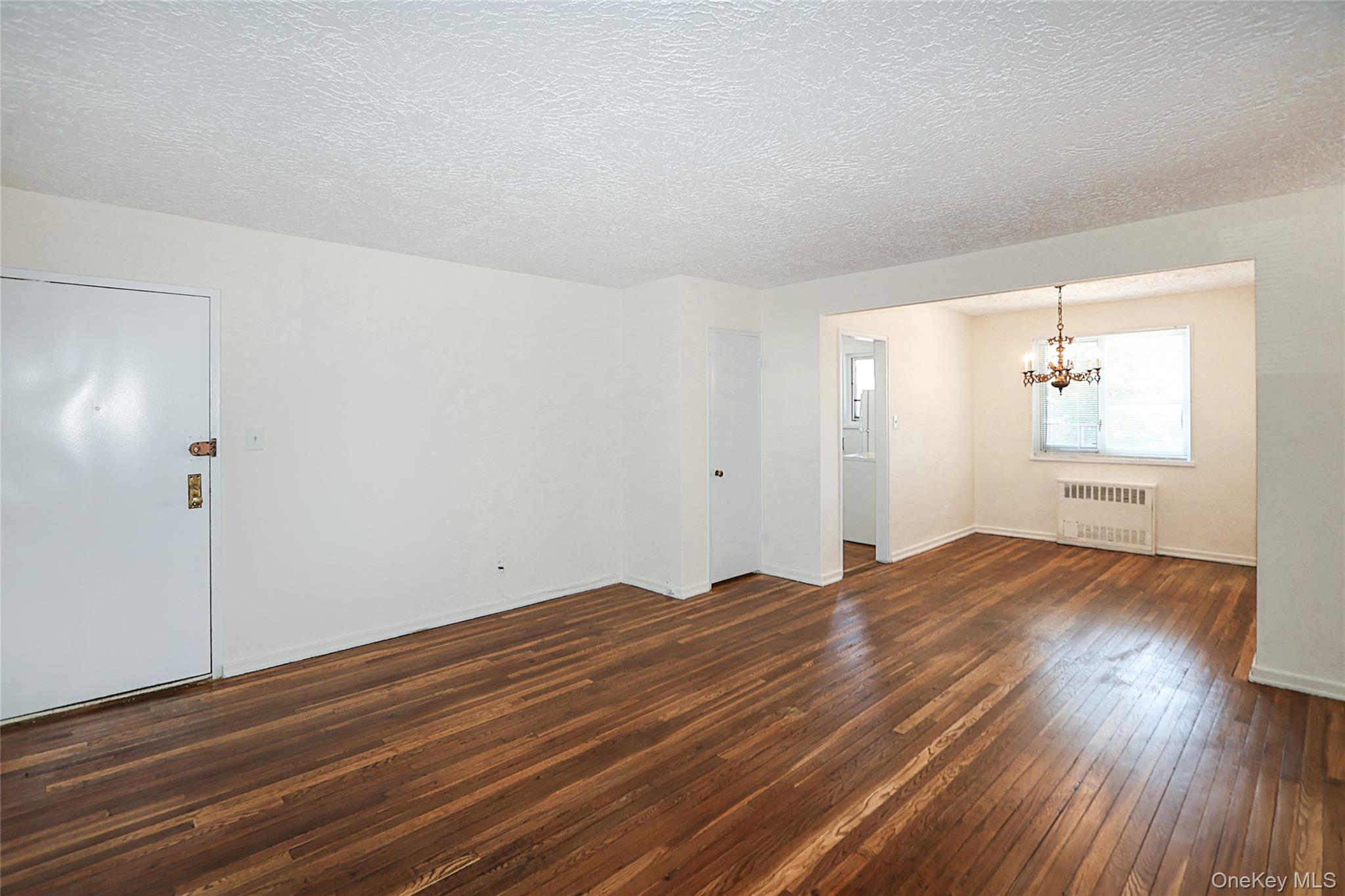 220-04 Stronghurst Avenue, Unit 185 Queens, NY 11427 - Photo 8 of 33 a view of empty room with wooden floor and fan