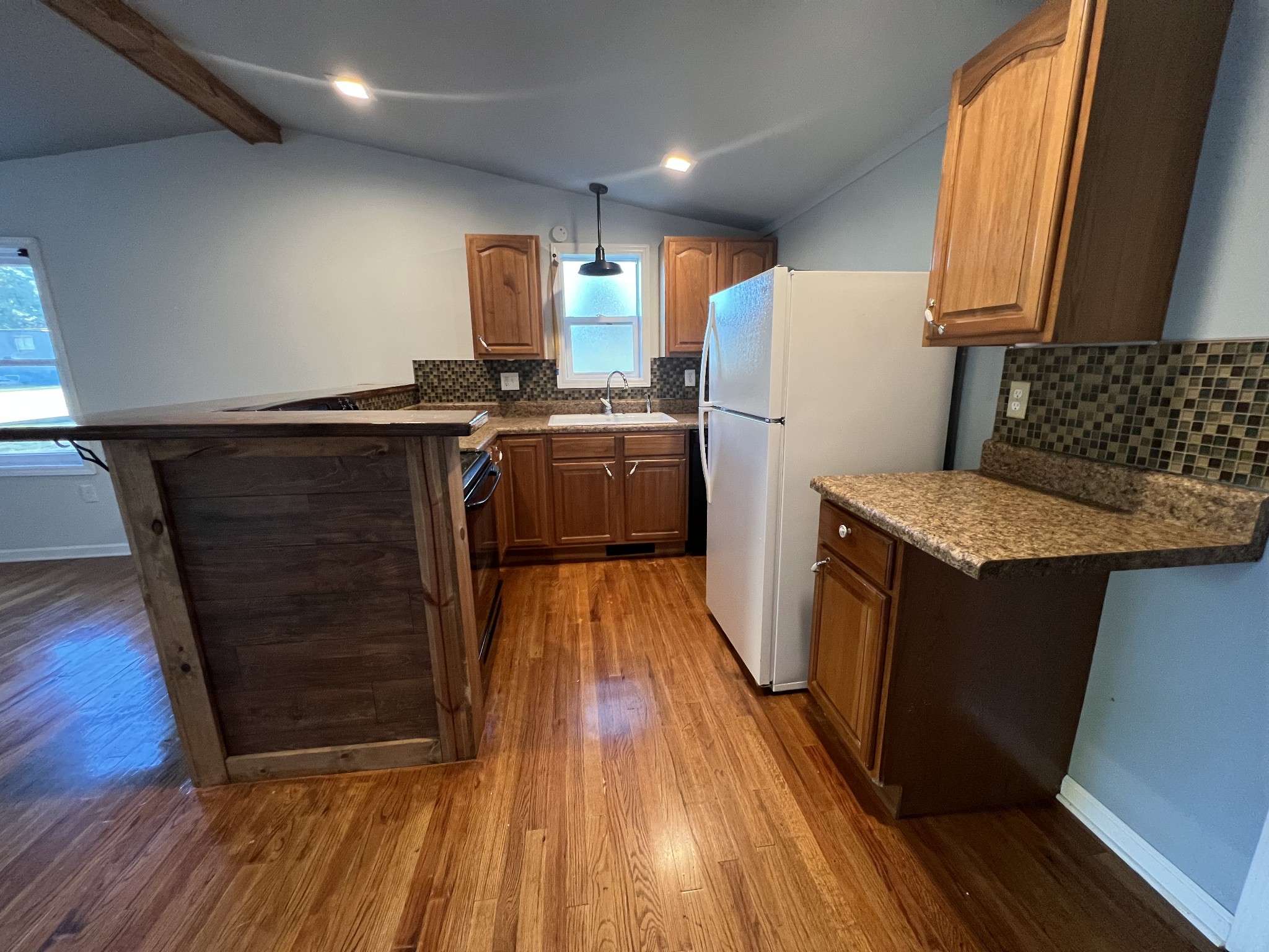 405 North 2nd Street Decherd, TN 37324 - Photo 3 of 11 a kitchen with sink a refrigerator and wooden floor
