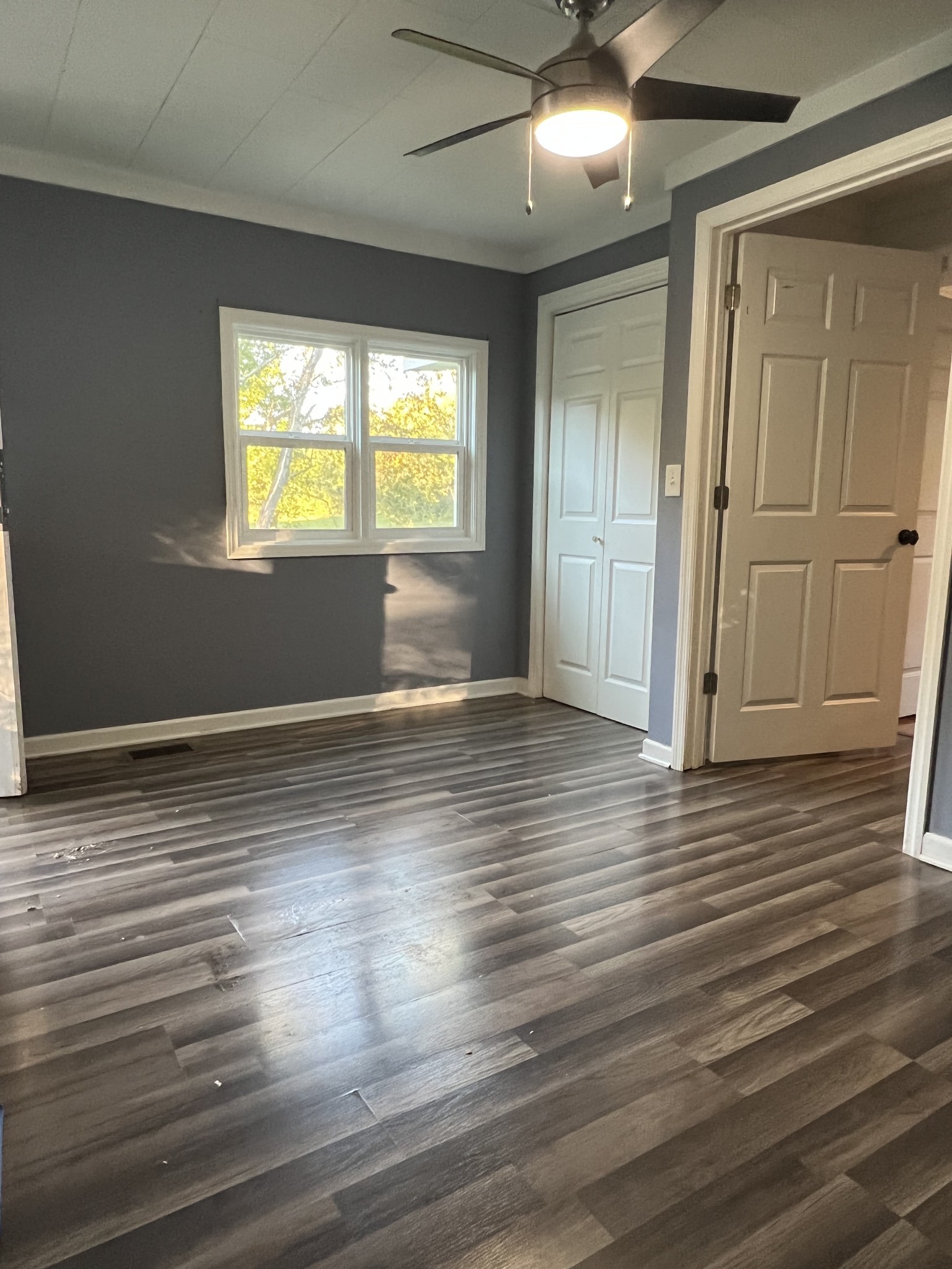 405 North 2nd Street Decherd, TN 37324 - Photo 9 of 11 an empty room with wooden floor and windows