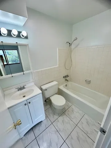 a bathroom with a sink a toilet and bathtub