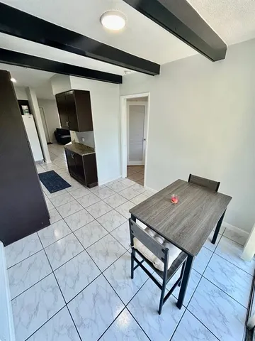 a room with a bed and a television