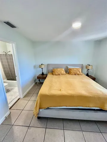 a bedroom with a bed and a mirror