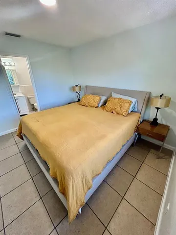 a bed sitting in a bedroom next to a window