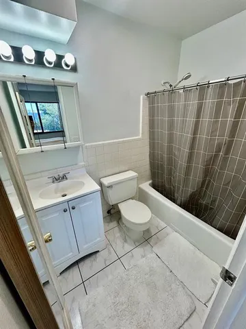 a bathroom with a sink a toilet and mirror