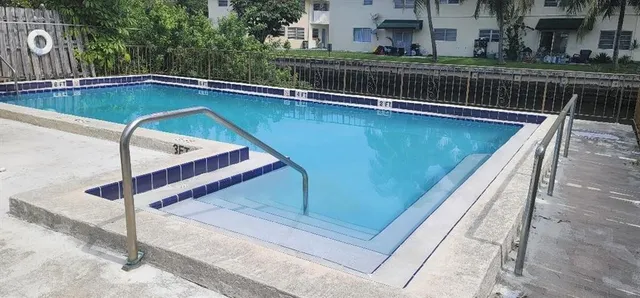 a view of swimming pool with chairs