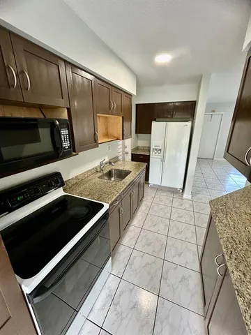 a kitchen with a stove and a microwave