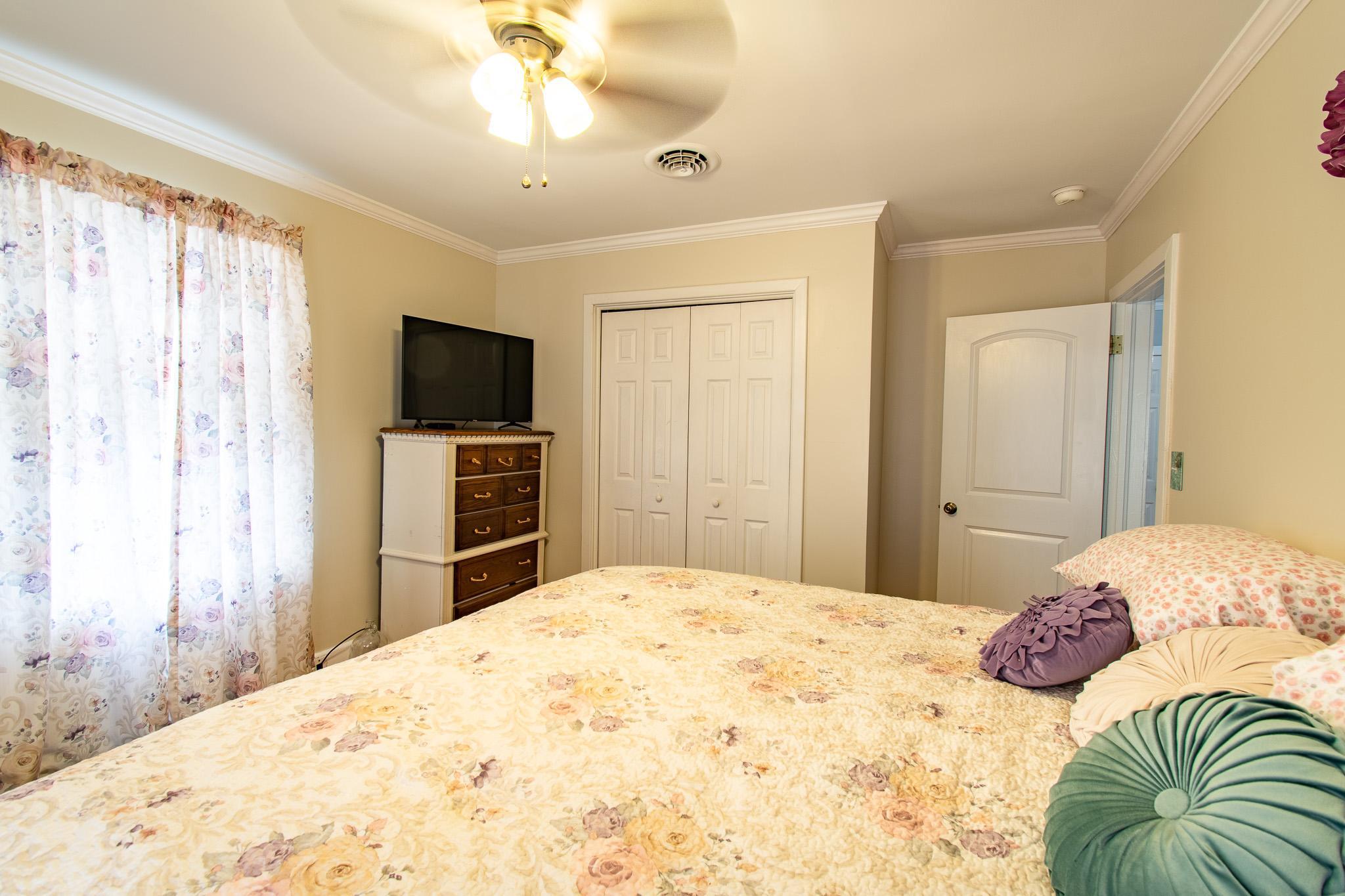 9 Oak Street Cambridge, MD 21613 - Photo 13 of 29 a bedroom with a bed and a flat screen tv