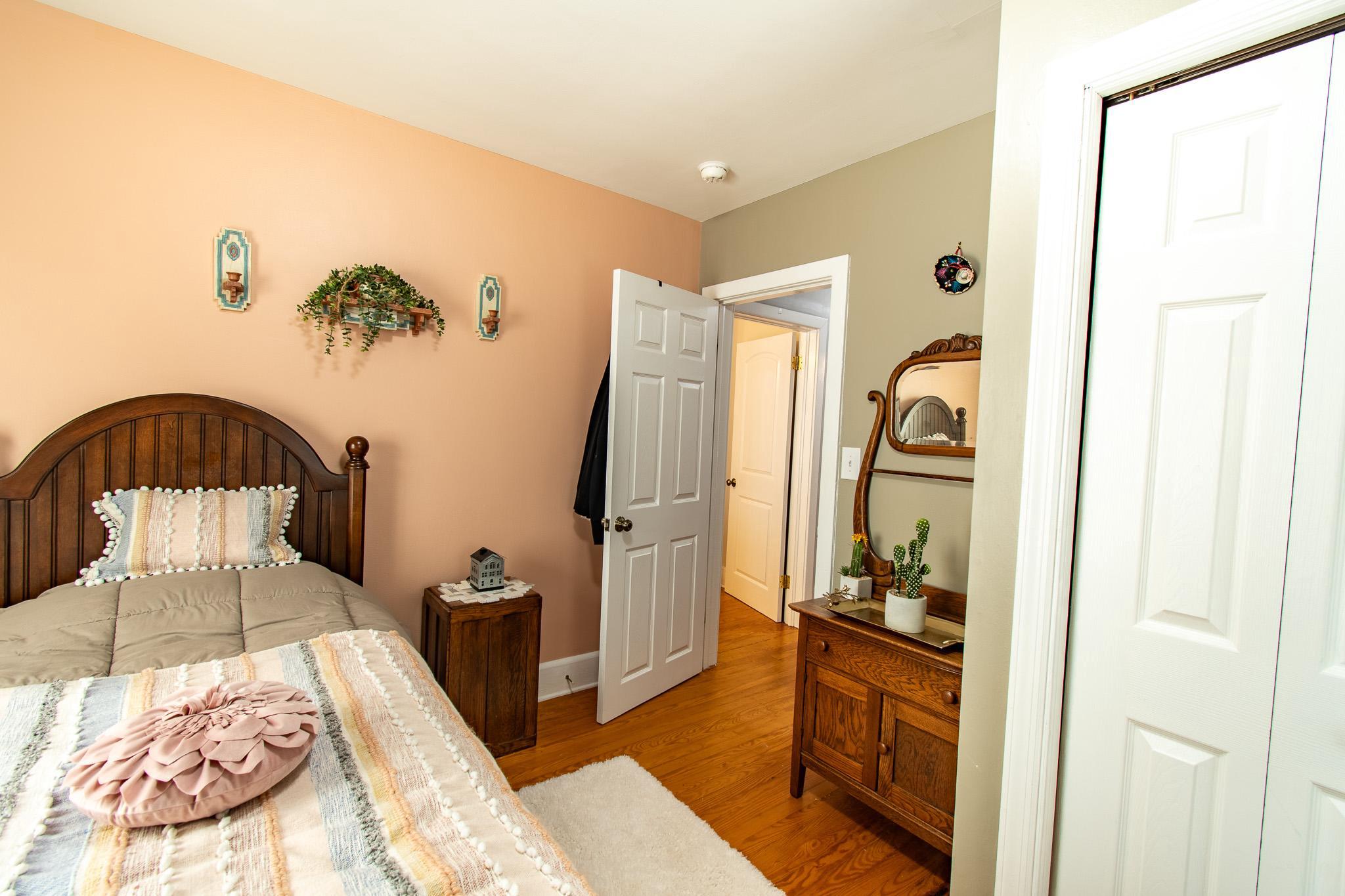 9 Oak Street Cambridge, MD 21613 - Photo 16 of 29 a bedroom with a bed and a large mirror on the dresser