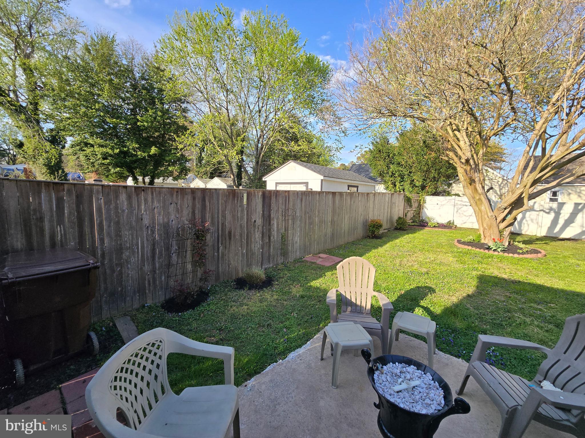 9 Oak Street Cambridge, MD 21613 - Photo 20 of 29 a view of backyard with table and chairs and a barbeque with a large tree
