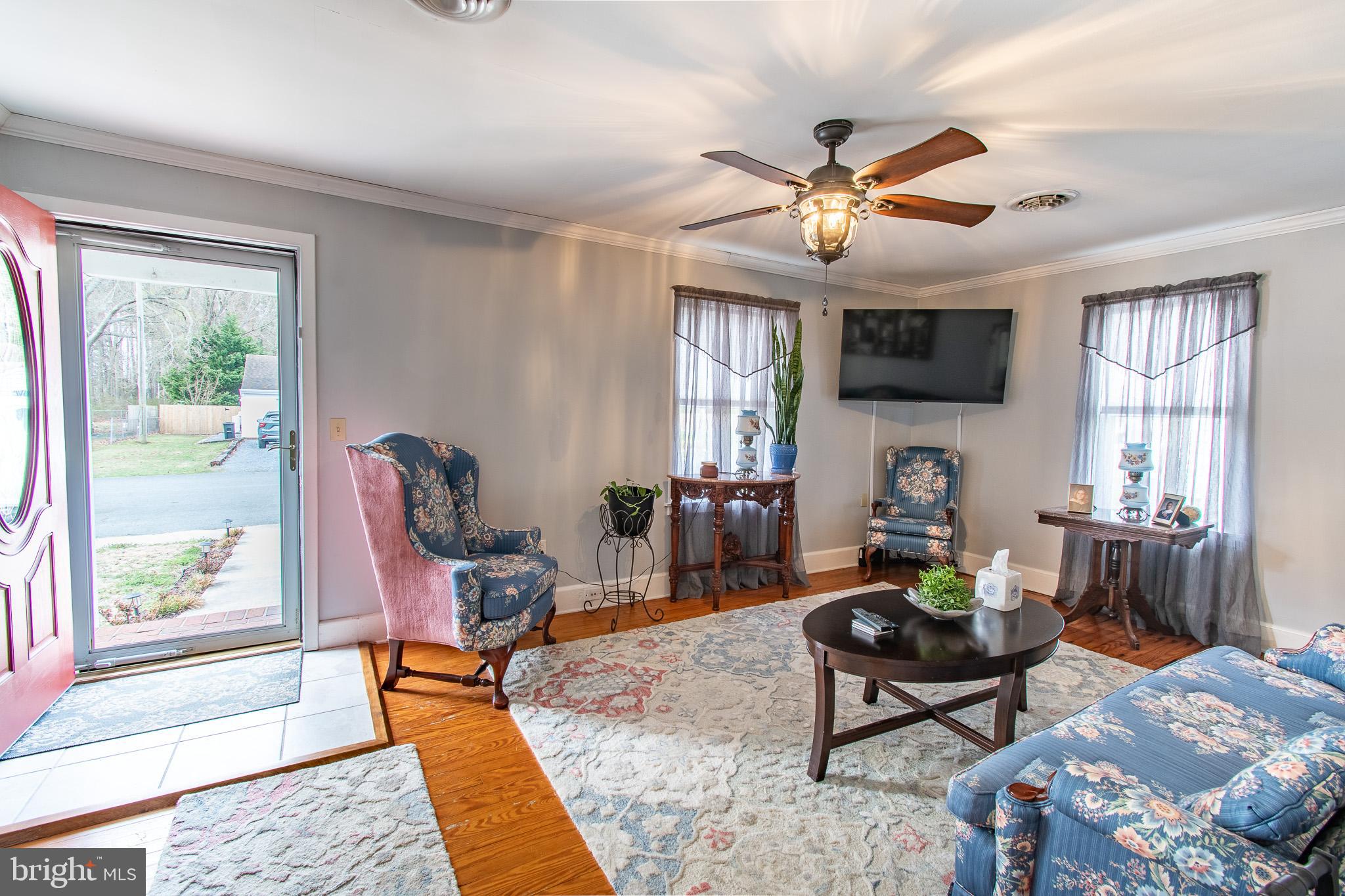 9 Oak Street Cambridge, MD 21613 - Photo 2 of 29 a living room with furniture a fireplace and a flat screen tv