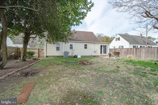a view of a yard in front of a house with large tree