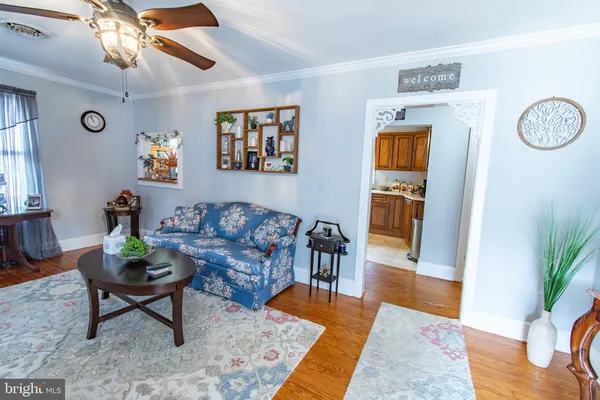 a living room with furniture a rug and a chandelier