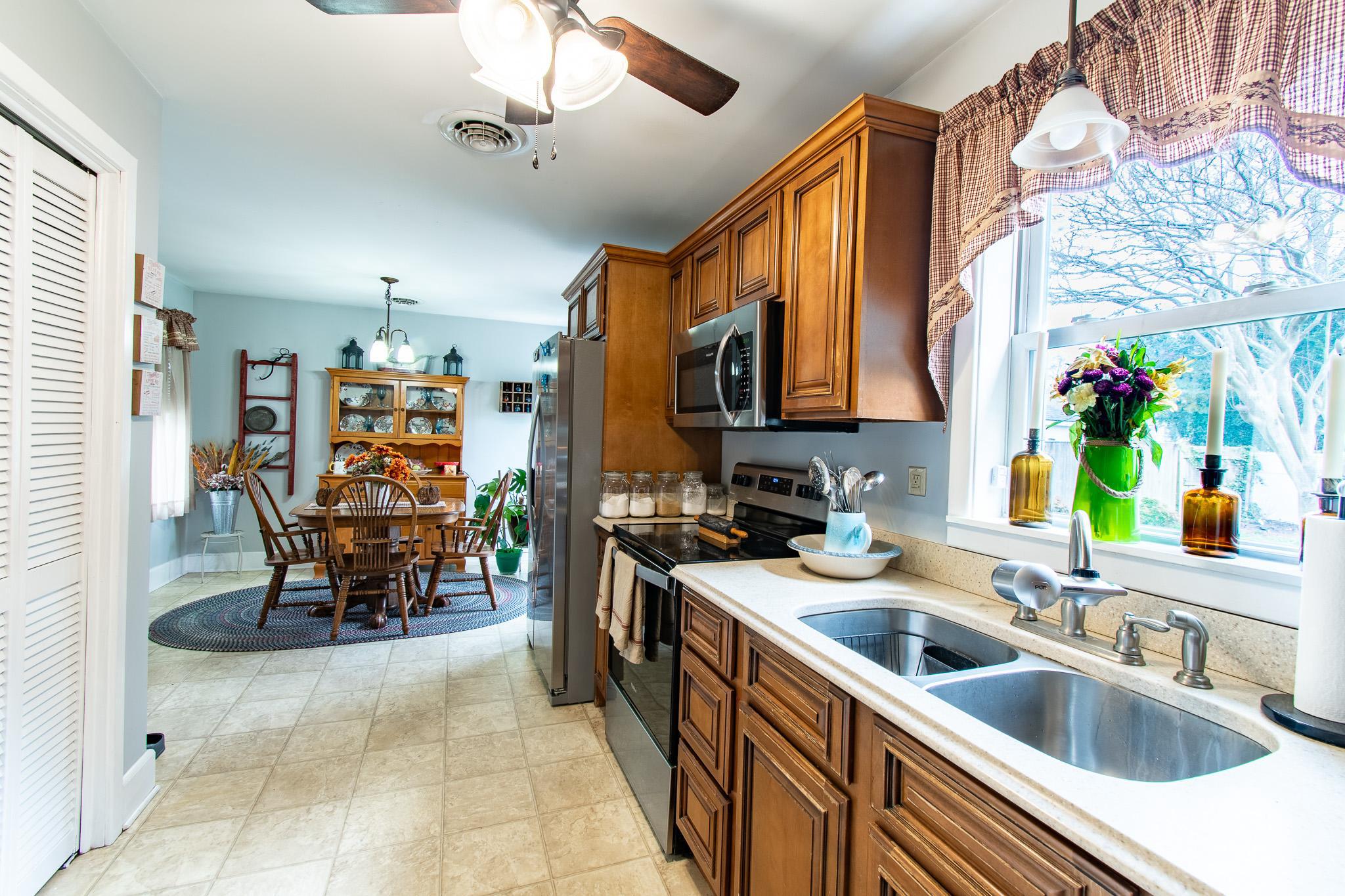 9 Oak Street Cambridge, MD 21613 - Photo 9 of 29 a kitchen with stainless steel appliances granite countertop a sink and cabinets