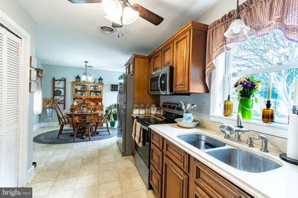 a kitchen filled with stainless steel appliances a sink and a refrigerator